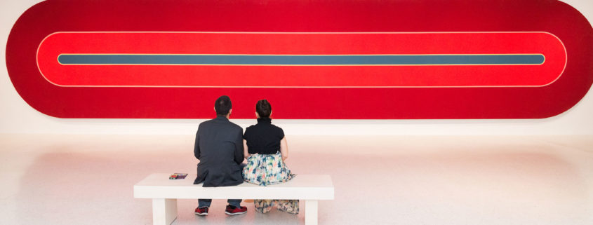 2 people looking at Frank Stella Experiment and Change at NSU Art Museum Fort Lauderdale.