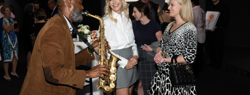 Saxophonist playing to Curator Circle members