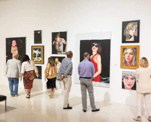 Museum guests looking at artworks