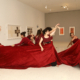 Dancers in red inside museum gallery