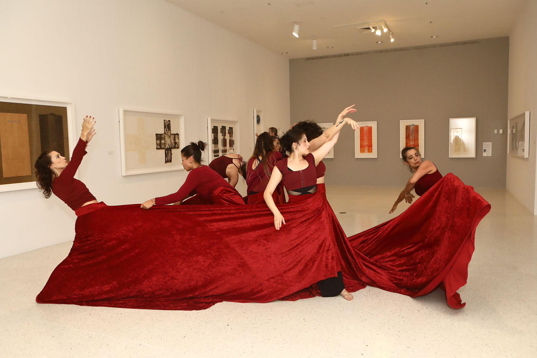 Dancers in red inside museum gallery