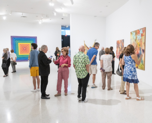 Museum guests looking at art