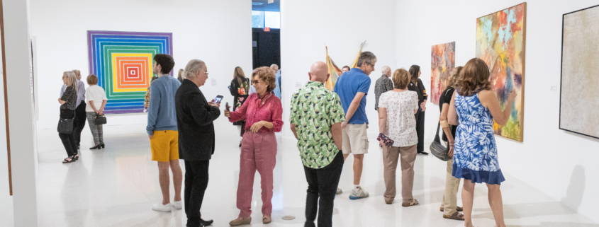 Museum guests looking at art