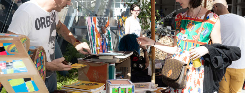 Woman buying art at flea market