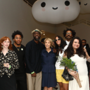 Group of people inside NSU Art Museum smiling at camera
