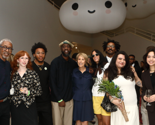 Group of people inside NSU Art Museum smiling at camera