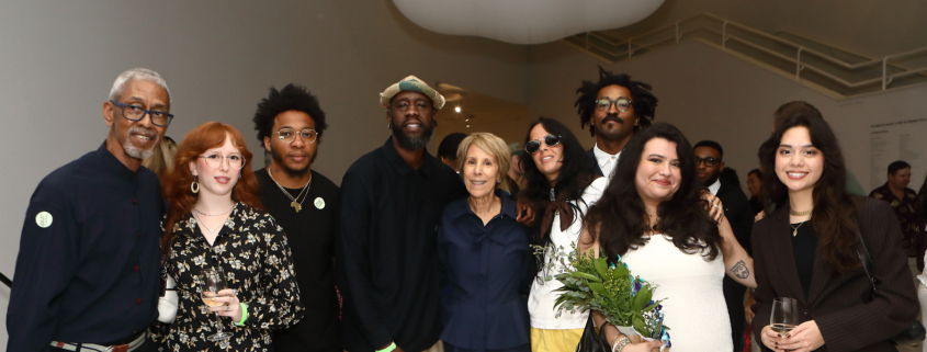 Group of people inside NSU Art Museum smiling at camera