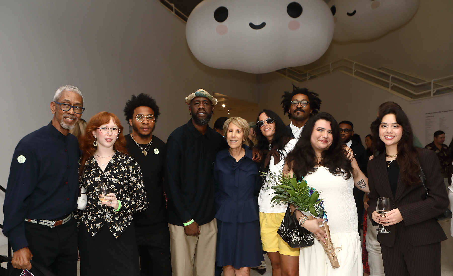 Group of people inside NSU Art Museum smiling at camera